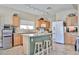 Kitchen showcasing an island with bar seating, granite countertops, and stainless steel appliances at 15040 W Windrose Dr, Surprise, AZ 85379