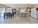 Open-concept kitchen featuring tile flooring, granite countertops, and an island with seating at 15040 W Windrose Dr, Surprise, AZ 85379