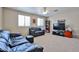 Cozy living room with plush leather seating, a bookcase, and a television, perfect for relaxation at 15040 W Windrose Dr, Surprise, AZ 85379