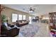 Open living space with tile floors flowing into the dining area and kitchen at 15040 W Windrose Dr, Surprise, AZ 85379