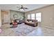 Cozy living room featuring tile floors, ample seating, and natural light from the windows at 15040 W Windrose Dr, Surprise, AZ 85379