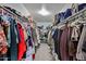 Spacious walk-in closet with ample storage and well-organized clothing racks at 15040 W Windrose Dr, Surprise, AZ 85379