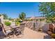 Desert backyard features outdoor dining set, a stucco wall and mature landscaping at 1552 E Manor Dr, Casa Grande, AZ 85122