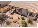 Aerial view of desert landscaped backyard featuring covered patio, dining table, cacti and shrubbery at 1552 E Manor Dr, Casa Grande, AZ 85122