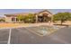 Exterior view of the clubhouse, featuring accessible parking and mature trees at 1552 E Manor Dr, Casa Grande, AZ 85122