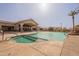 Resort-style community pool area with a jacuzzi, clubhouse, and lush landscaping at 1552 E Manor Dr, Casa Grande, AZ 85122