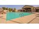Community pool with a well-maintained deck and views of the clubhouse at 1552 E Manor Dr, Casa Grande, AZ 85122