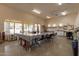 Spacious craft room with large tables, ample natural light, and plenty of storage at 1552 E Manor Dr, Casa Grande, AZ 85122