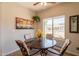 Charming dining room features a round table and a view to the yard at 1552 E Manor Dr, Casa Grande, AZ 85122