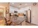 Well-equipped kitchen with granite countertops, stainless steel appliances, and breakfast bar at 1552 E Manor Dr, Casa Grande, AZ 85122
