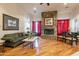 Inviting living room featuring a stone fireplace, hardwood floors, and comfortable seating at 1552 E Manor Dr, Casa Grande, AZ 85122