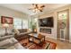 Cozy living room features a modern fireplace, ceiling fan and patio access at 1552 E Manor Dr, Casa Grande, AZ 85122