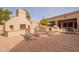 Outdoor kitchen area with a grill, lounge chairs, and shaded seating at 1552 E Manor Dr, Casa Grande, AZ 85122
