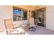 Covered patio features desert landscaping, a sliding glass door and comfortable seating arrangements at 1552 E Manor Dr, Casa Grande, AZ 85122