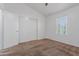 Bright bedroom featuring neutral carpet, a window and a closet with sliding doors at 1600 N Saba St # 151, Chandler, AZ 85225
