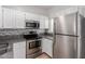 Modern kitchen featuring stainless steel appliances, granite countertops, and white cabinetry at 1600 N Saba St # 151, Chandler, AZ 85225