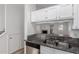 Bright kitchen featuring granite countertops and a view into the living room at 1600 N Saba St # 151, Chandler, AZ 85225