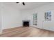 Bright living room with wood floors, fireplace, and a ceiling fan at 1600 N Saba St # 151, Chandler, AZ 85225