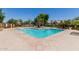 Community pool with lounge chairs and shade covering for outdoor enjoyment at 1600 N Saba St # 151, Chandler, AZ 85225
