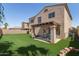Backyard featuring a covered patio and artificial turf lawn at 16118 W Port Au Prince Ln, Surprise, AZ 85379