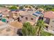 Spacious backyard with a covered patio and palm tree, creating an inviting outdoor space at 16118 W Port Au Prince Ln, Surprise, AZ 85379