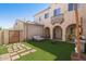 Backyard featuring outdoor seating, artificial turf, and a barbecue grill at 16118 W Port Au Prince Ln, Surprise, AZ 85379