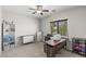 Functional bedroom with sewing station, shelving, and a bright window at 16118 W Port Au Prince Ln, Surprise, AZ 85379