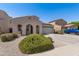 View of a single Gathering house with an arched porch, two car garage, desert landscaping and a blue truck at 16118 W Port Au Prince Ln, Surprise, AZ 85379