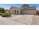 Spacious single-Gathering home showcasing an arched porch, 3-car garage, desert landscaping, and solar panels at 16118 W Port Au Prince Ln, Surprise, AZ 85379