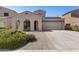 Charming single-Gathering home showcasing an arched porch, two-car garage, desert landscaping, and solar panels at 16118 W Port Au Prince Ln, Surprise, AZ 85379