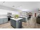Open kitchen features a large island, stainless steel appliances, and a dining area at 16118 W Port Au Prince Ln, Surprise, AZ 85379