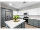 Stylish kitchen features stainless steel appliances, and white and gray cabinets at 16118 W Port Au Prince Ln, Surprise, AZ 85379
