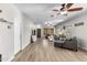 Comfortable living room features neutral tones, wood floors, ceiling fans, and lots of natural light at 16118 W Port Au Prince Ln, Surprise, AZ 85379