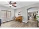 View of a living room featuring hardwood floors, a guitar hanging on the wall and a piano in the corner at 16118 W Port Au Prince Ln, Surprise, AZ 85379