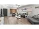 Inviting living room features hardwood floors, neutral decor, ceiling fan, and comfortable seating arrangement at 16118 W Port Au Prince Ln, Surprise, AZ 85379
