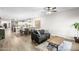 Bright open concept living room and dining area with a view into the modern kitchen at 16118 W Port Au Prince Ln, Surprise, AZ 85379