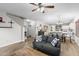 Open-concept living room with view of dining area and entry to the main bedroom at 16118 W Port Au Prince Ln, Surprise, AZ 85379