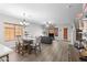 Bright living room and dining area with wood floors, chandelier, and comfortable seating at 16118 W Port Au Prince Ln, Surprise, AZ 85379