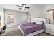 Well-lit main bedroom featuring neutral colors, carpeted floors, and two windows with wooden blinds at 16118 W Port Au Prince Ln, Surprise, AZ 85379