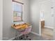 Cozy room with a sewing table and chair, and a window overlooking the exterior at 16118 W Port Au Prince Ln, Surprise, AZ 85379