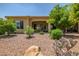 An open backyard with desert landscaping and a covered patio, perfect for outdoor entertaining at 16426 W Piccadilly Rd, Goodyear, AZ 85395
