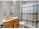 Bathroom with single vanity and shower and tub combo with decorative striped curtain at 16426 W Piccadilly Rd, Goodyear, AZ 85395