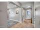Inviting entryway featuring neutral tones, tile flooring, and seamless transition to living spaces at 16426 W Piccadilly Rd, Goodyear, AZ 85395
