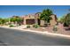 Charming stucco home featuring a two-car garage, desert landscaping, and a welcoming front entrance at 16426 W Piccadilly Rd, Goodyear, AZ 85395