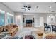 Open-concept living room with a TV, shelving, and seamless flow to the kitchen and dining area at 16426 W Piccadilly Rd, Goodyear, AZ 85395