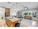 Open-concept living space with kitchen island and views of the patio and outside landscaping at 16426 W Piccadilly Rd, Goodyear, AZ 85395
