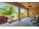 Covered patio features decorative ceiling fan and overlooks a yard featuring desert landscaping at 16426 W Piccadilly Rd, Goodyear, AZ 85395
