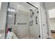 Bright shower features sleek glass enclosure, handheld shower and grab bars for easy access at 16426 W Piccadilly Rd, Goodyear, AZ 85395