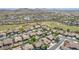 Wide aerial view of homes and community showing nearby golf course, surrounding desert landscape, and mountain views at 18199 W Buckhorn Dr, Goodyear, AZ 85338