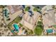 Aerial view of home showing tile roof, backyard oasis with pool, spa, fire pit, covered patio, and desert landscaping at 18199 W Buckhorn Dr, Goodyear, AZ 85338
